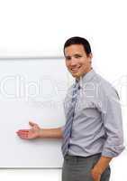 Assertive young businessman pointing at a board