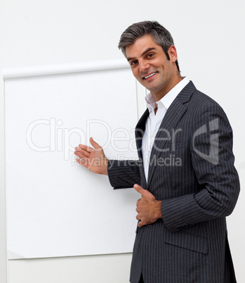 Self-assured male executive pointing at a board