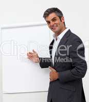Self-assured male executive pointing at a board