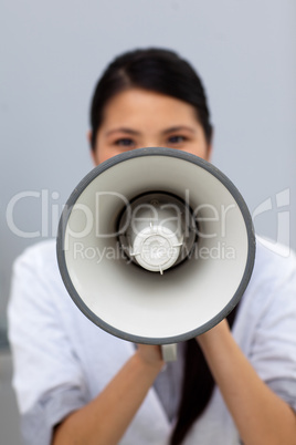 Young businesswoman shouting instructions