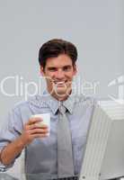 Happy caucasian businessman holding a drinking cup