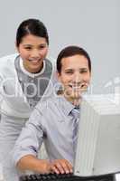 Smiling businesswoman helping her colleague