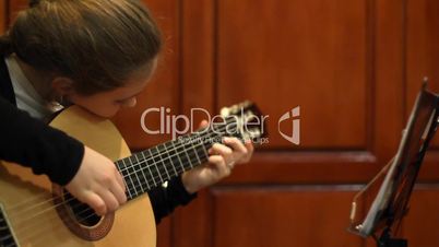 girl plays a guitar.