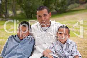 Hispanic Father and Sons in the Park