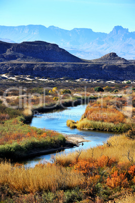 Image of winding stream in front of mountains