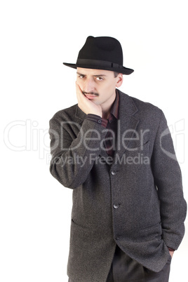 Suspicious man in hat looking at camera