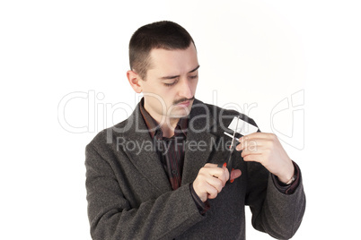 Sad man cutting a credit card