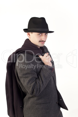 Man in hat with coat on shoulder