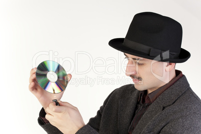 Man in hat burning a compact disc