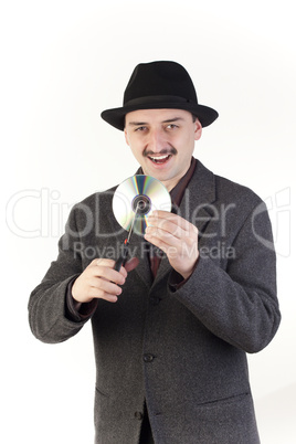 Man in hat cutting a compact disc