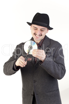 Man in hat cutting a compact disc