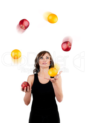 Beautiful woman juggling apples and oranges on a white backgroun