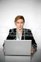 Beautiful young businesswoman chained to laptop