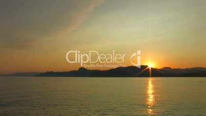 HD sea and rocks at sunset with clouds wide