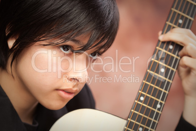 Attractive Ethnic Girl Plays Guitar