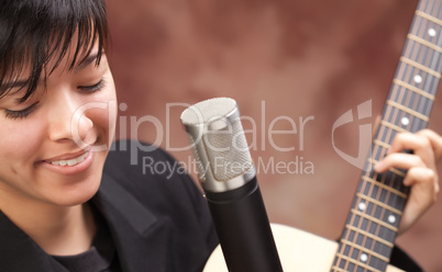 Attractive Ethnic Girl Plays Guitar