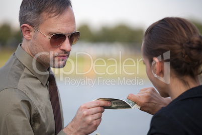 man and woman pulling on dollars