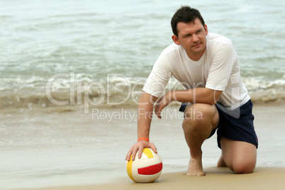 Man with volleyball on the beach
