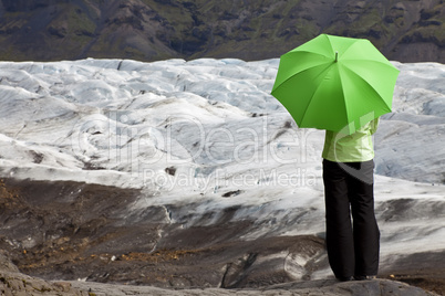 Environmental Concept Of A Woman With Green Umbrella By Glacier