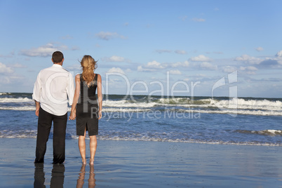 Romantic Man and Woman Couple Holding Hands On A Beach