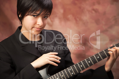 Multiethnic Girl Poses with Electric Guitar