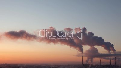 Pipe with smoke in winter sunset time lapse