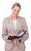 Young businesswoman making notes on her agenda