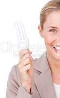 Close-up of a businesswoman holding a saving energy light bulb