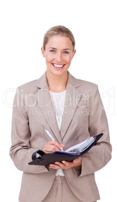 Assertive businesswoman making notes on her agenda