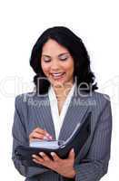 Ethnic businesswoman making notes on her agenda