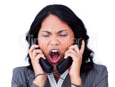 Frustrated businesswoman tangled up in phone wires