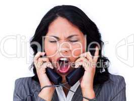 Frustrated businesswoman tangled up in phone wires