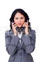 Stressed businesswoman tangled up in phone wires