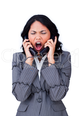 Angry businesswoman tangled up in phone wires