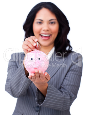Self-assured young businesswoman saving money in a piggybank
