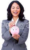 Positive businesswoman saving money in a piggybank