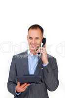 Smiling businessman using a phone