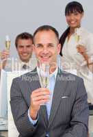 Multi-ethnic business co-workers toasting with Champagne