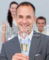 Cheerful businessman toasting with Champagne