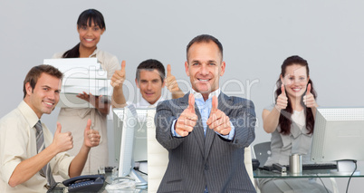 Assertive manager and his team with thumbs up