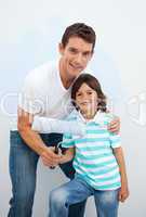 Smiling Father and his boy paiting a room
