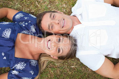 Happy couple lying on the grass