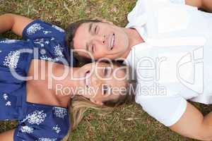 Happy couple lying on the grass