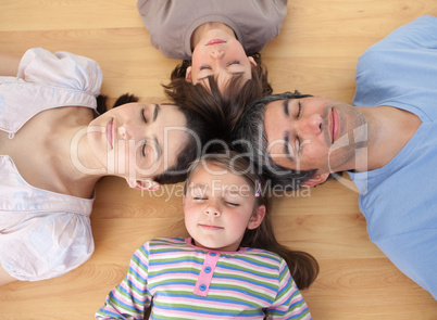 Merry family sleeping lying on the floor