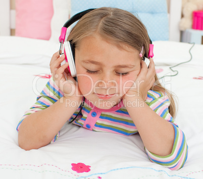 Close-up of a Little gril listening to music with headphones