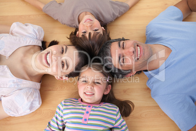 Lively family lying on the floor