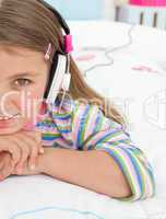 Little gril listening to music with headphones