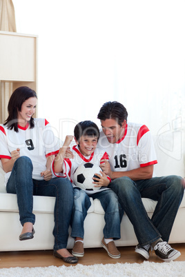 Excited family celebrating a goal
