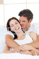 Caring man kissing his laughing wife