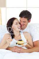 couple eating on their bed